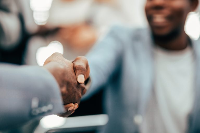 image of a handshake of business executives leadership team meeting