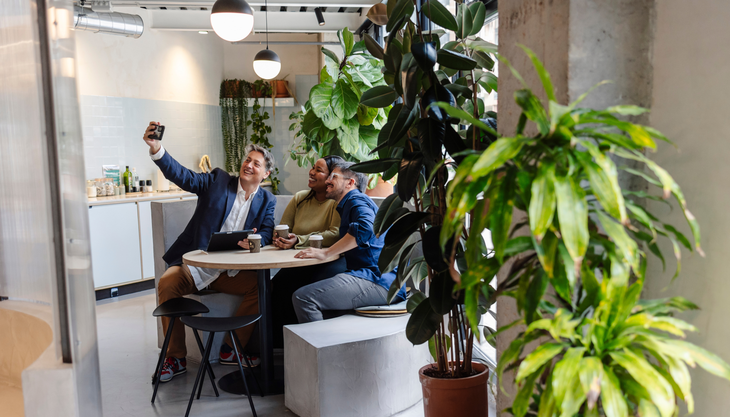 a culture of employees in the workplace taking a selfie together