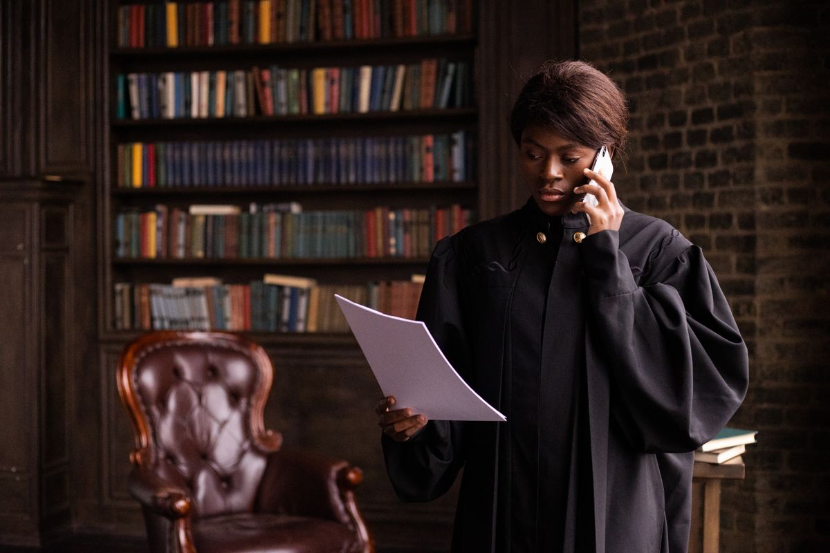 workers compensation lawyer looking at documents contracts while on the phone