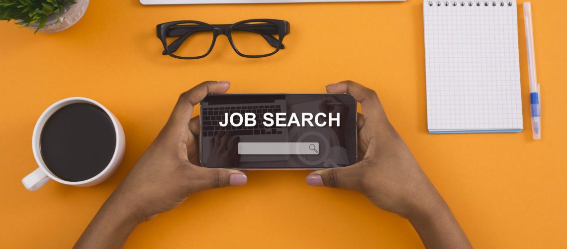 Employment Concept. Above top view of black woman holding smart phone with job search engine app on screen, isolated. Job search, hiring, talent acquisition, recruitment