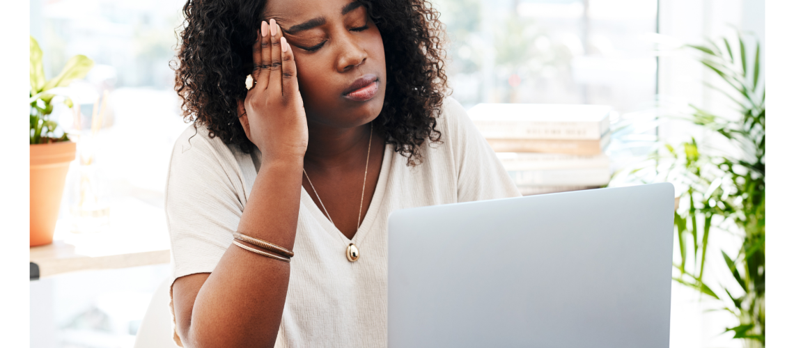 headache tired employee female sitting at her desk stressed overwhelmed cannot focus struggle timelines deadlines