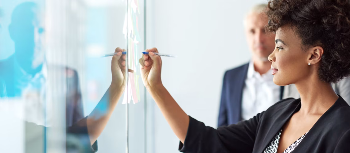 succession planning where a younger employee is working with a senior leader under leadership explaining a concept with notes