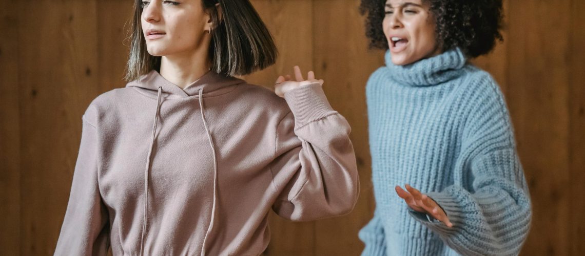 two women fighting not happy upset employees culture wellness